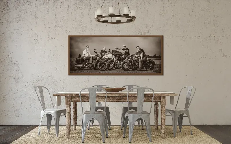 A long framed family portrait on an exposed brick wall above a bench